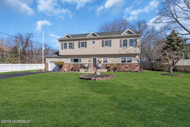 551 Chester Pkwy, Belford, NJ 07718 - colonial-style house featuring aphalt driveway, fence, and a front lawn