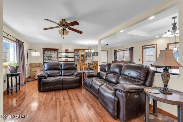 551 Chester Pkwy, Belford, NJ 07718 - living area with plenty of natural light, ceiling fan with notable chandelier, and light wood-type flooring