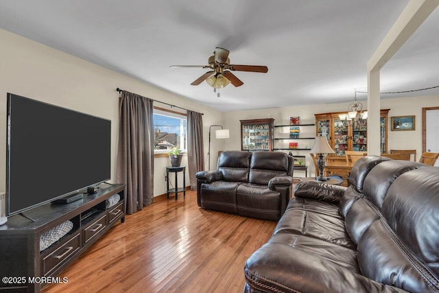 551 Chester Pkwy, Belford, NJ 07718 - living room with ceiling fan with notable chandelier and light wood finished floors