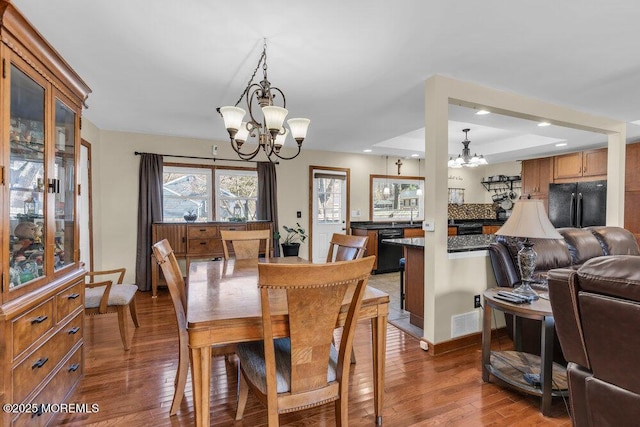 551 Chester Pkwy, Belford, NJ 07718 - dining area with visible vents, an inviting chandelier, and hardwood / wood-style floors