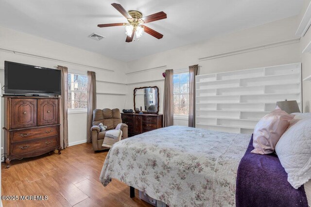 551 Chester Pkwy, Belford, NJ 07718 - bedroom featuring ceiling fan, visible vents, multiple windows, and wood finished floors