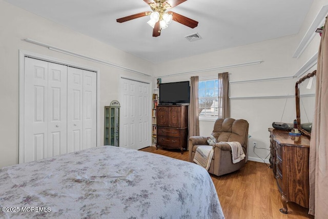 551 Chester Pkwy, Belford, NJ 07718 - bedroom featuring ceiling fan, wood finished floors, visible vents, and multiple closets