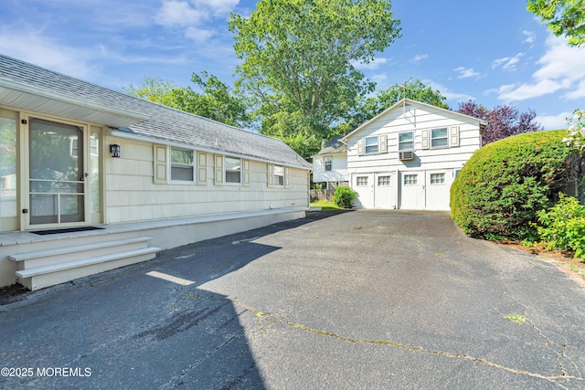 view of property exterior featuring a residential view and roof with shingles