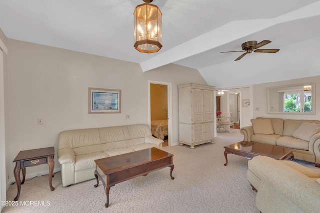 living room with ceiling fan, vaulted ceiling with beams, and light colored carpet