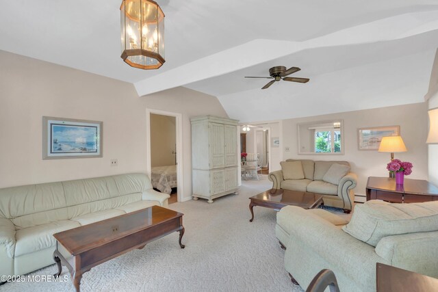 living area featuring a baseboard heating unit, light colored carpet, vaulted ceiling with beams, and ceiling fan