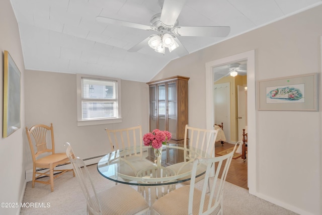 dining room with lofted ceiling, baseboards, a baseboard heating unit, and a ceiling fan