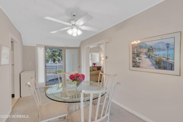 dining space featuring carpet floors, baseboards, and a ceiling fan