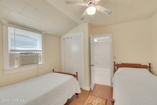 bedroom with a ceiling fan, cooling unit, a closet, and lofted ceiling