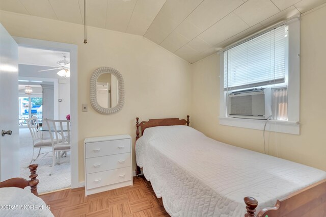 bedroom with lofted ceiling and cooling unit