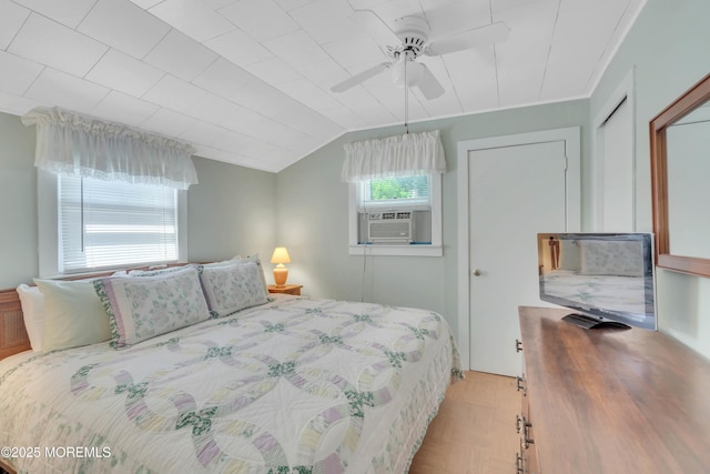 bedroom with vaulted ceiling, cooling unit, and a ceiling fan