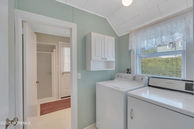 laundry area with washing machine and clothes dryer and cabinet space