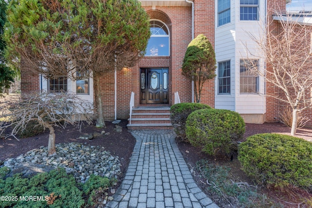 entrance to property with brick siding