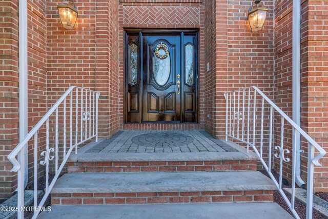 property entrance with brick siding