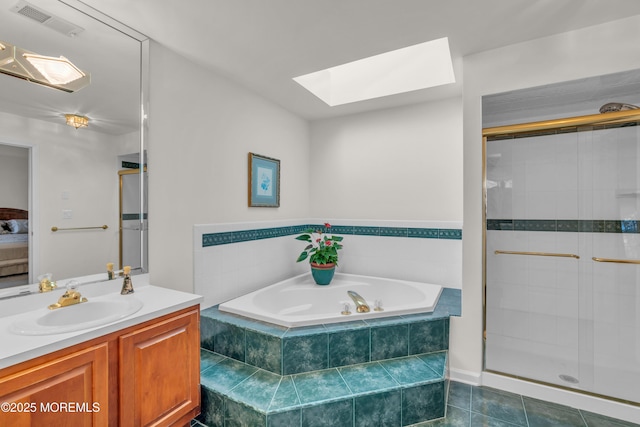 ensuite bathroom featuring visible vents, a garden tub, a skylight, and a shower stall