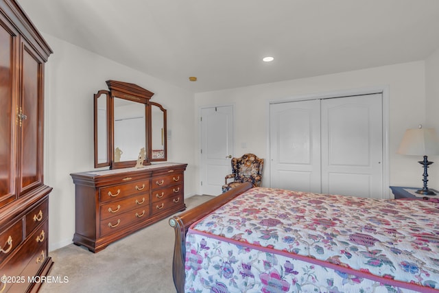 bedroom with baseboards, recessed lighting, a closet, and light carpet