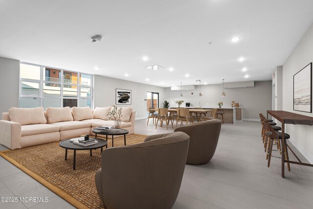 living room featuring baseboards and recessed lighting