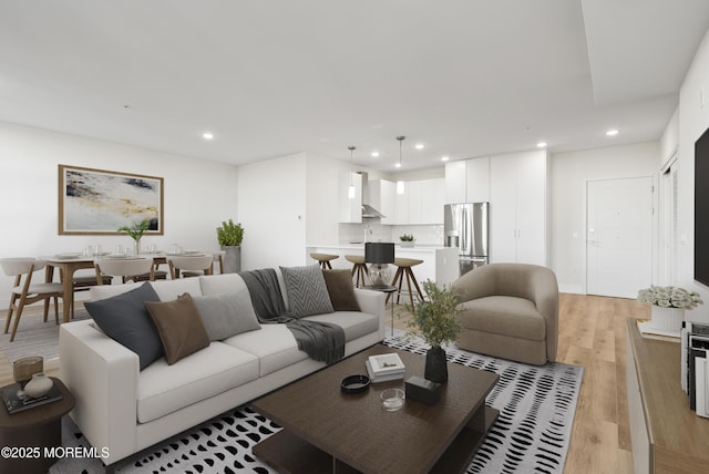 living room with light wood finished floors and recessed lighting