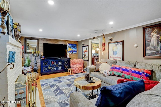 living room with recessed lighting, crown molding, and wood finished floors