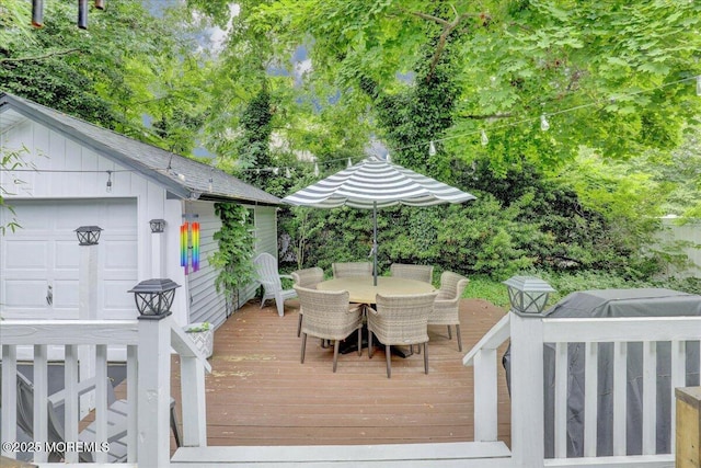 wooden deck featuring outdoor dining space and an outdoor structure