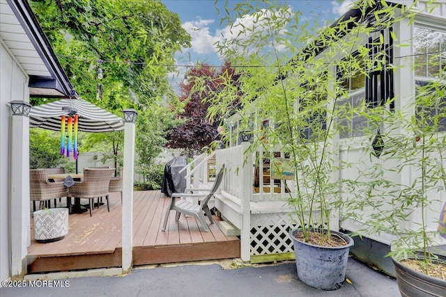 wooden terrace featuring outdoor dining space