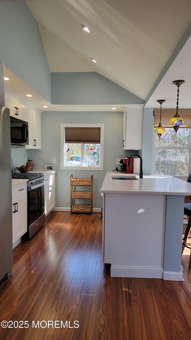 kitchen with white cabinets, appliances with stainless steel finishes, light countertops, and a sink