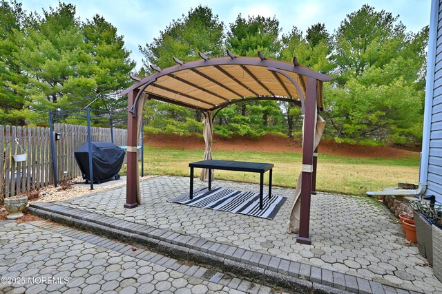 view of home's community with a lawn, a patio area, fence, and a pergola