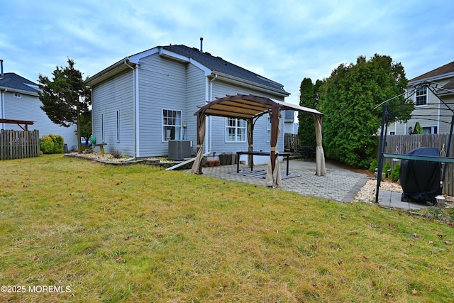 rear view of house featuring a patio area, a lawn, fence, and a pergola