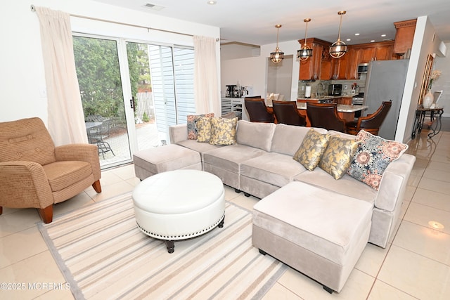 living area with recessed lighting and light tile patterned flooring