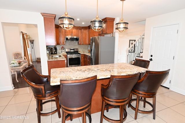 kitchen featuring light tile patterned floors, appliances with stainless steel finishes, a sink, and tasteful backsplash