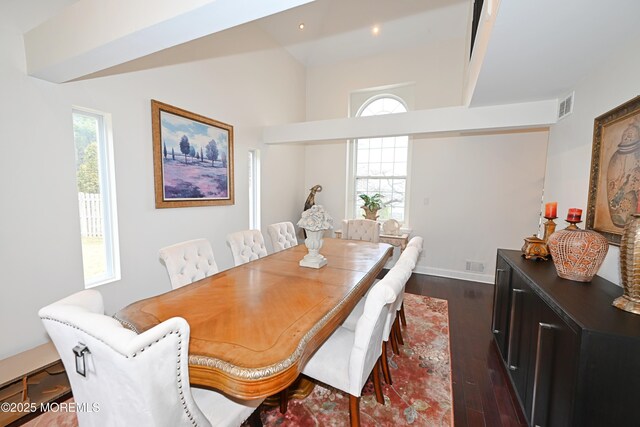 dining area featuring plenty of natural light, visible vents, and dark wood finished floors