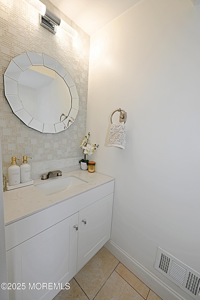 bathroom with tile patterned flooring, visible vents, baseboards, and vanity