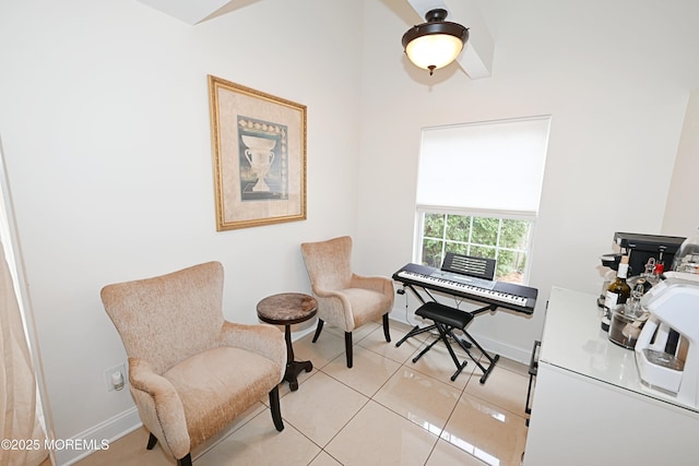 living area with light tile patterned floors and baseboards