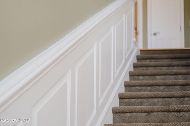 staircase with a decorative wall