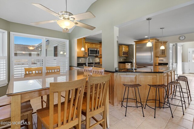 dining area with light tile patterned floors and ceiling fan