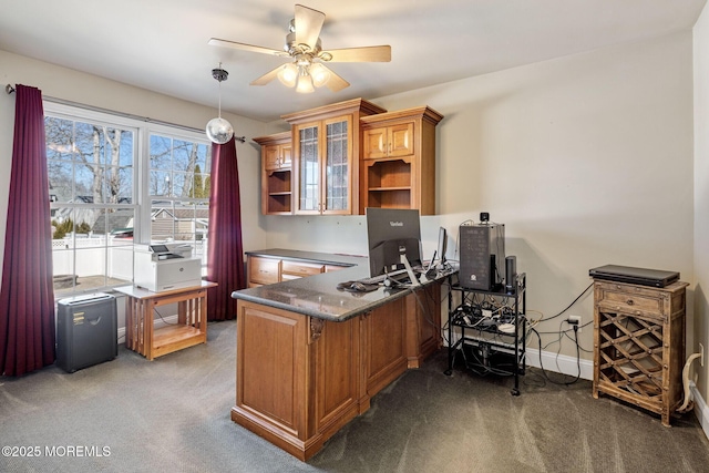 home office featuring carpet, baseboards, and a ceiling fan