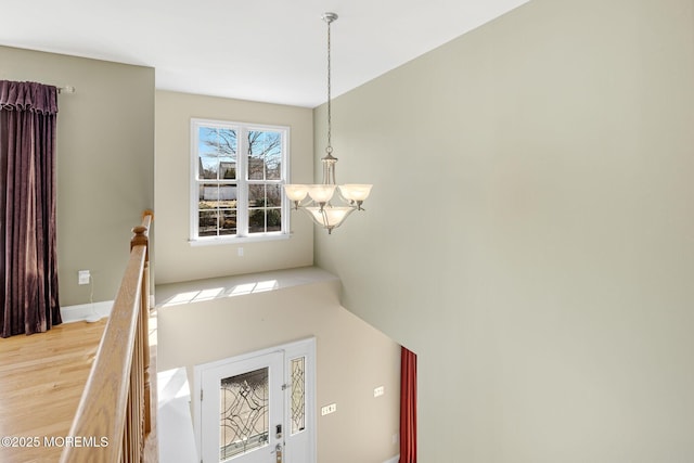 interior space with a chandelier and wood finished floors