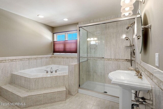 bathroom featuring a stall shower and a bath