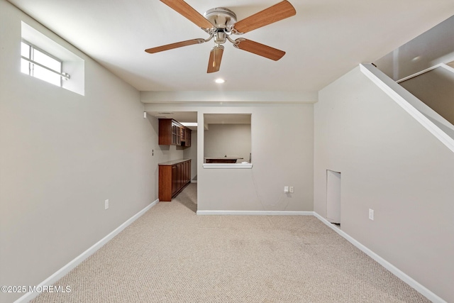 interior space featuring recessed lighting, ceiling fan, baseboards, and light colored carpet