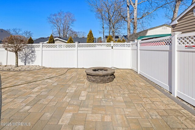 view of patio featuring a fire pit and a fenced backyard