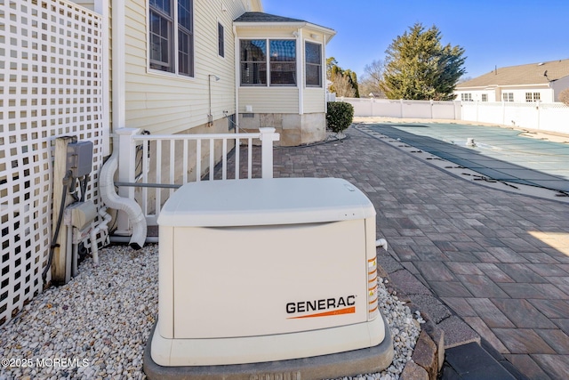 exterior details with a power unit, a swimming pool, and fence