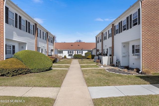 view of home's community with a yard and a residential view