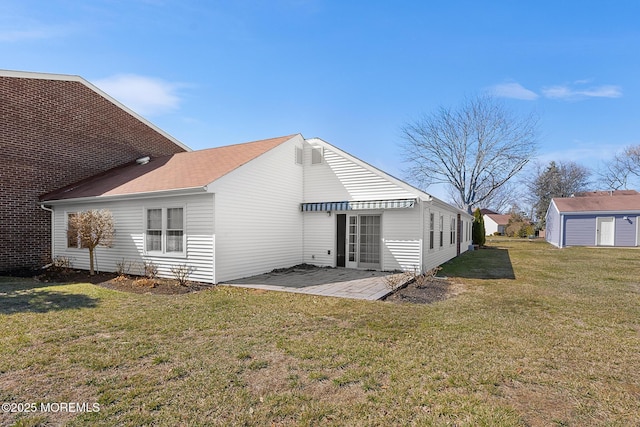 back of house featuring a yard and a patio