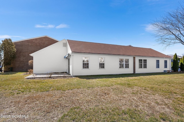 view of side of property with a lawn