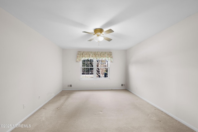 spare room featuring visible vents, carpet floors, baseboards, and a ceiling fan