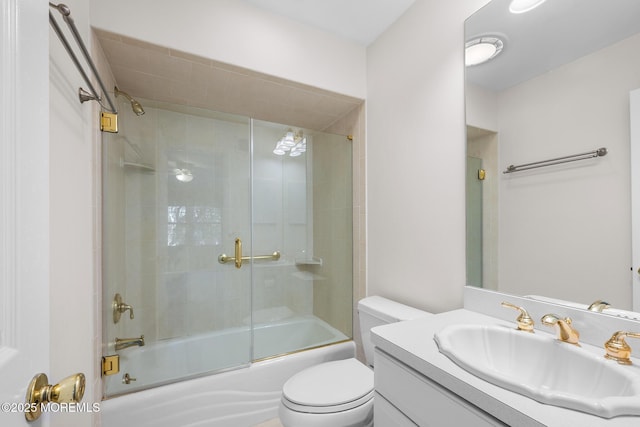 full bathroom with combined bath / shower with glass door, toilet, and vanity