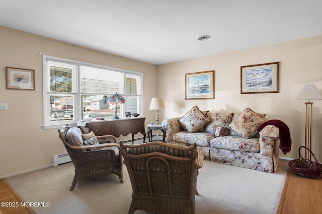 carpeted living room with a baseboard heating unit, visible vents, and baseboards