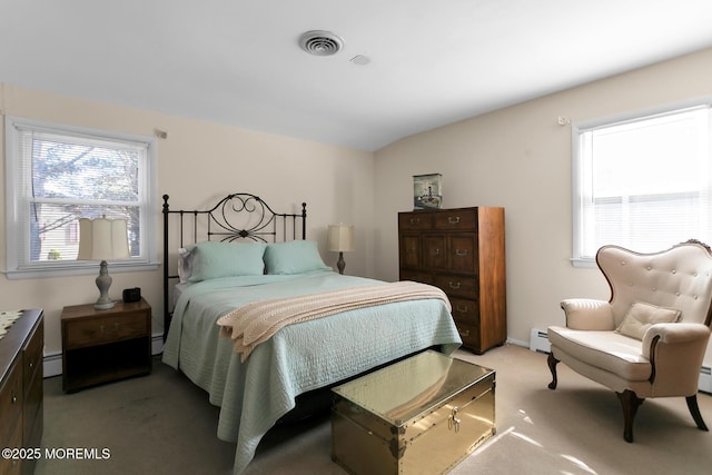 bedroom with a baseboard radiator, visible vents, vaulted ceiling, and multiple windows