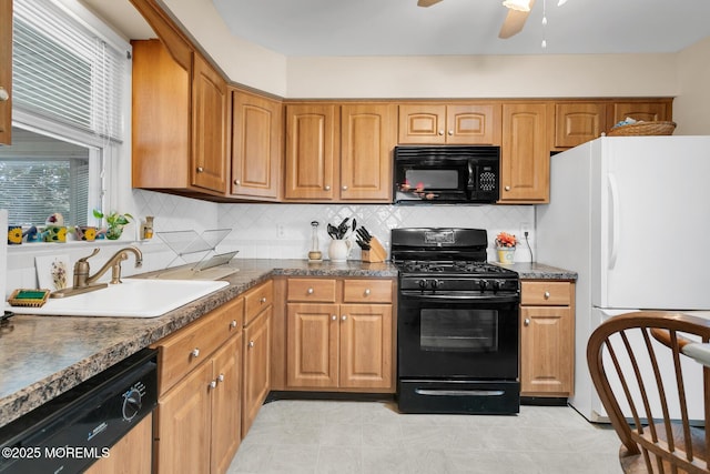 kitchen featuring brown cabinets, decorative backsplash, a ceiling fan, a sink, and black appliances