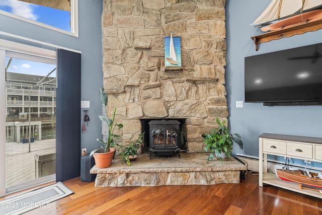 living area featuring a wood stove and wood finished floors