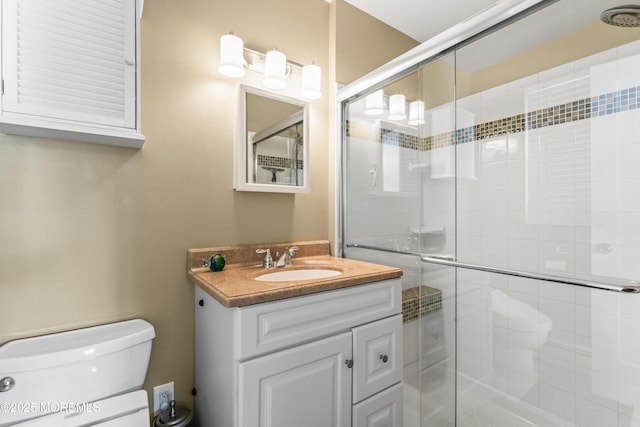 bathroom featuring a stall shower, vanity, and toilet